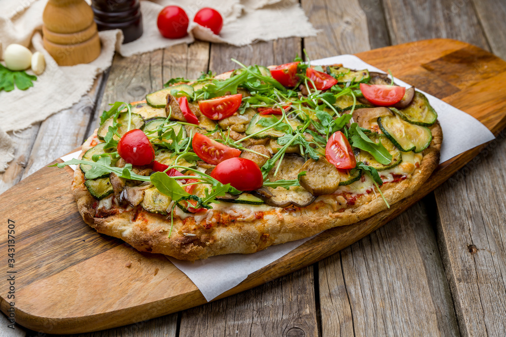vegetable pizza at the Rome dough, vegetarian pinsa on wooden table vegetable pizza at the Rome dough, vegetarian pinsa on wooden table