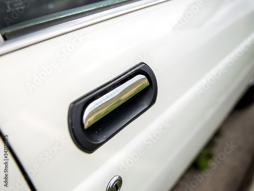 a car door handle from a white door