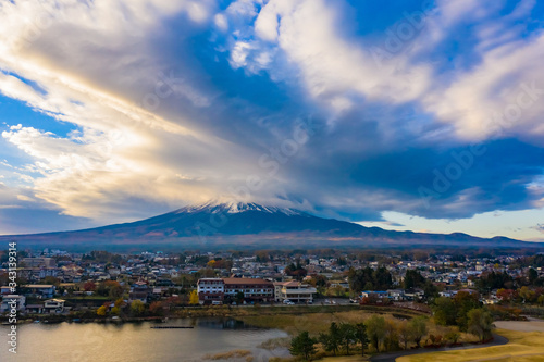 Japan. Volcano of Fuji in autumn day. Kawaguchiko Lake. Clouds over Mount Fujiyama. The city at the foot of the volcano. Landscape of the Japanese city. Panorama of Mount Fuji. Regions of Japan.