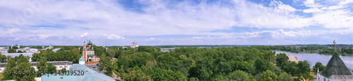 View of the Church of St. Michael the Archangel and the assumption Cathedral through the round window of the belfry of the Transfiguration monastery.