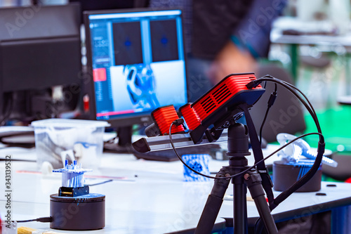 Scanner of three-dimensional parts. The device scans a volume part. 3D scanner. Creating three-dimensional models on the model. Equipment for 3D printing. Modern computer technology.