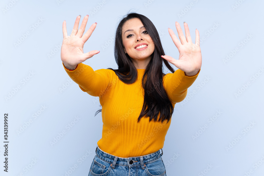 Young Colombian girl over isolated blue background counting ten with fingers Young Colombian girl over isolated blue background counting ten with fingers