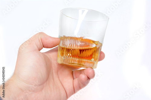 Tumbler Highball in man hand isolate on white