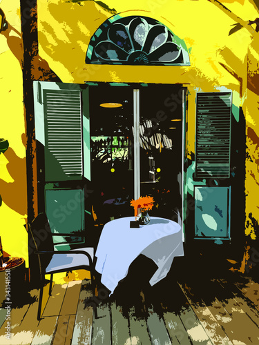 Coffee table covered with white cloth and yellow colonial-style European building