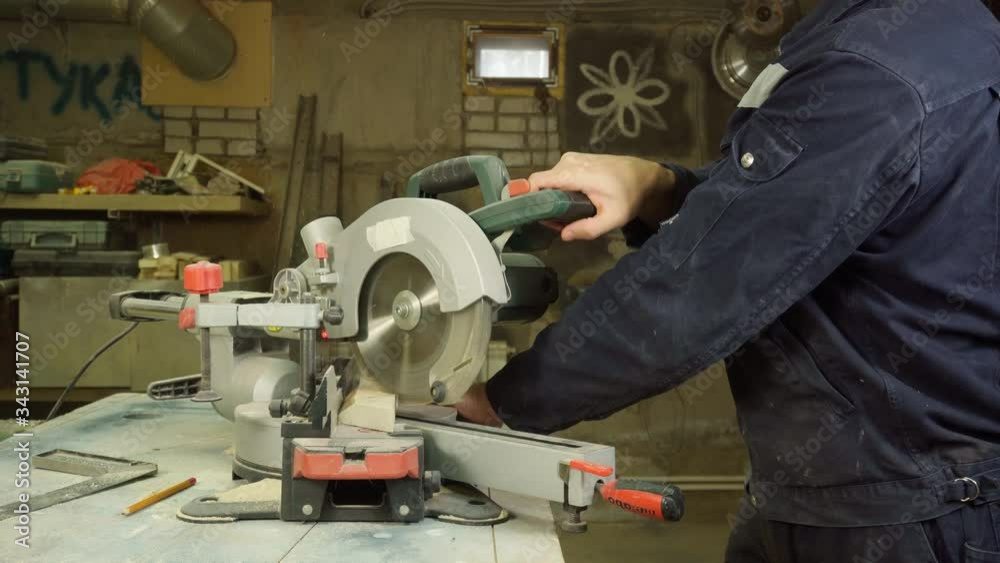Carpenter using circular saw for cutting wooden board. Carpenter using circular saw for cutting wooden board.
