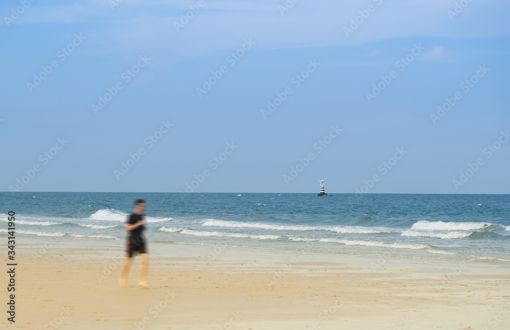 blur unidentified person running on sea waves and blue sky background  in beach summer concept