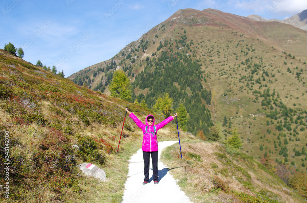 Fototapeta premium young girl smiles happy on mountain trails