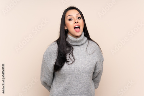 Young Colombian girl over isolated background with surprise facial expression