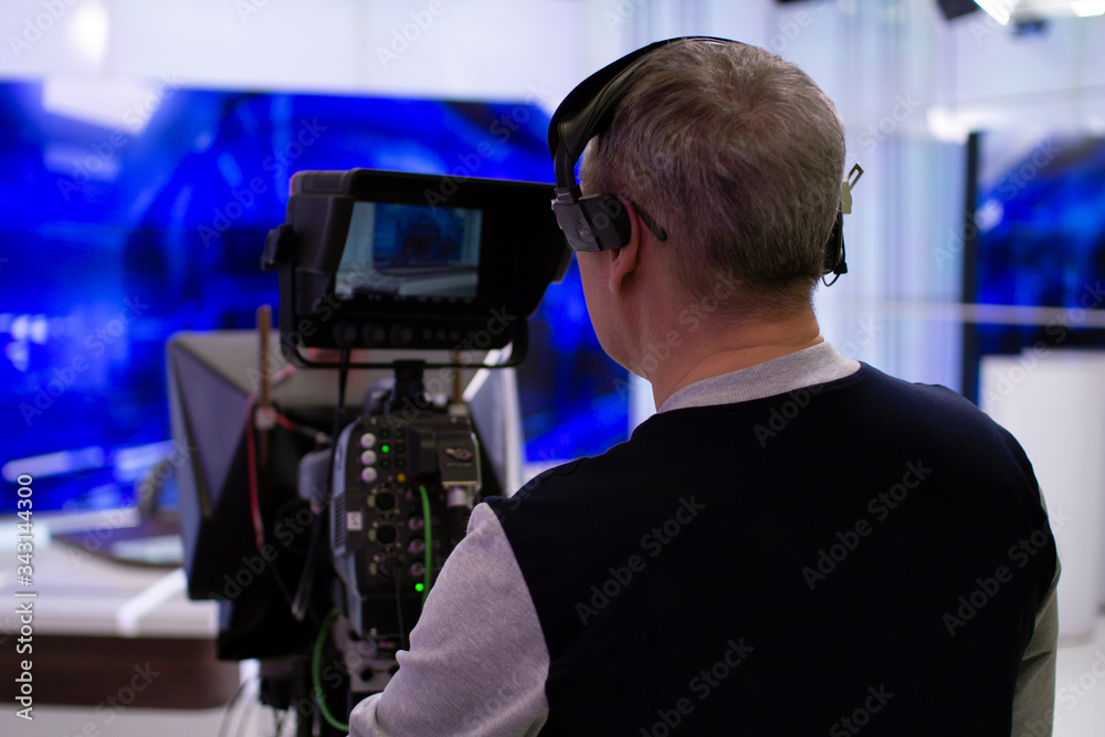 Professional cameraman working in a TV Studio. Professional cameraman working in a TV Studio.