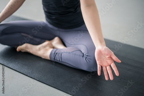 Woman practicing yoga in studio.