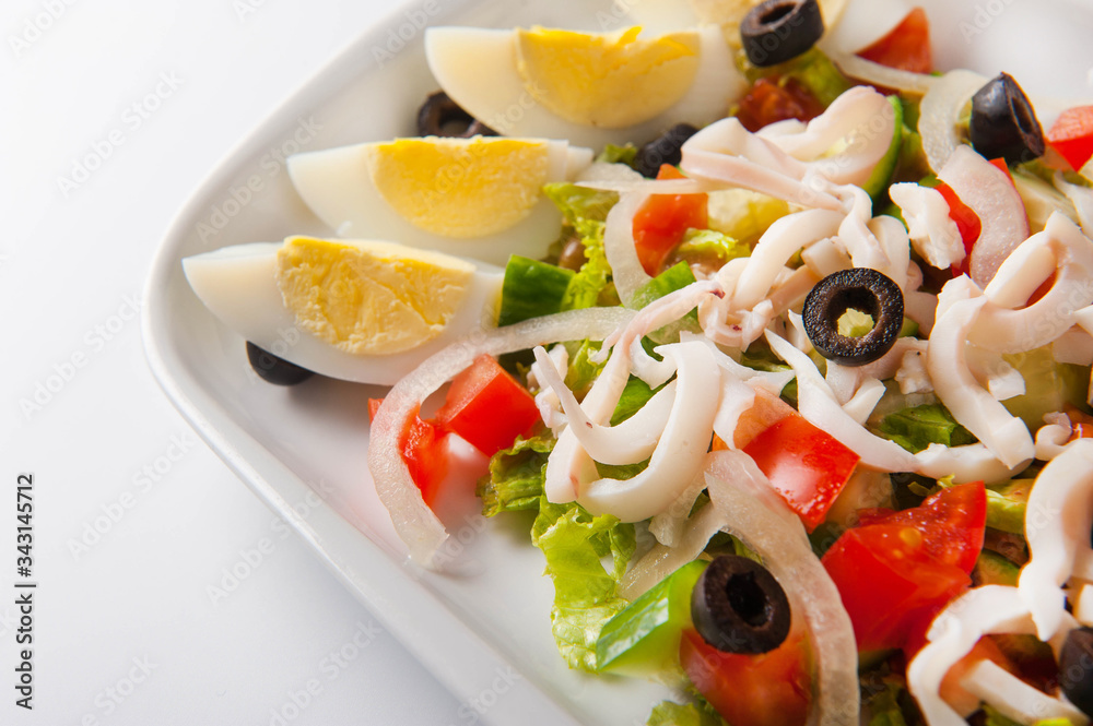 healthy salad in a white plate on a white background. Healthy eating Salad close up