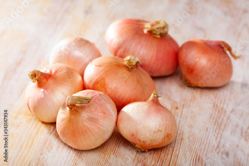 Onion bulbs on wooden background  nobody