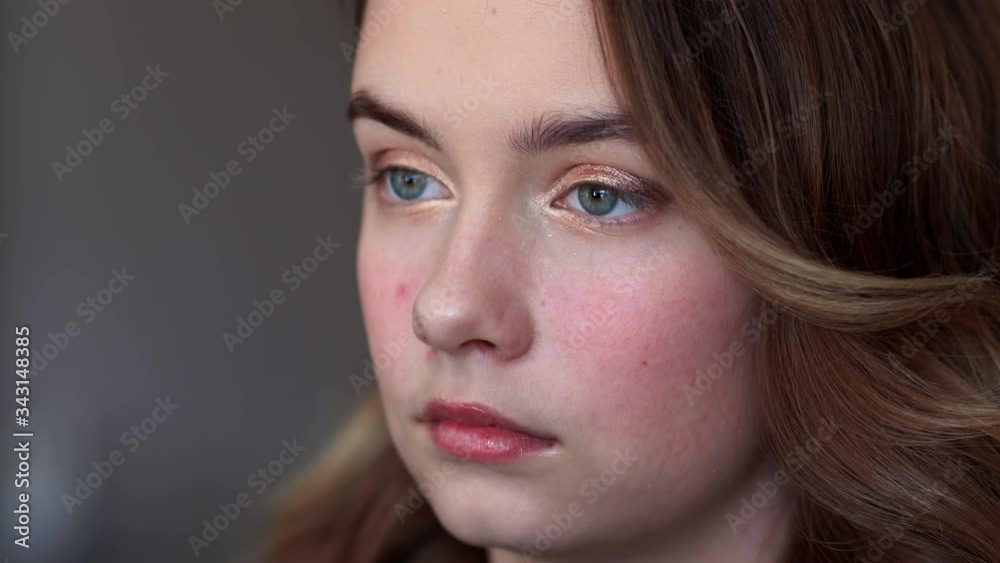 Makeup artist paints eyelids on a model girl. Makeup artist paints eyelids on a model girl.