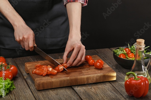 Woman cooking fresh vegetable salad. Female hands. Diet concept for healthy lifestyle with copyspace.
