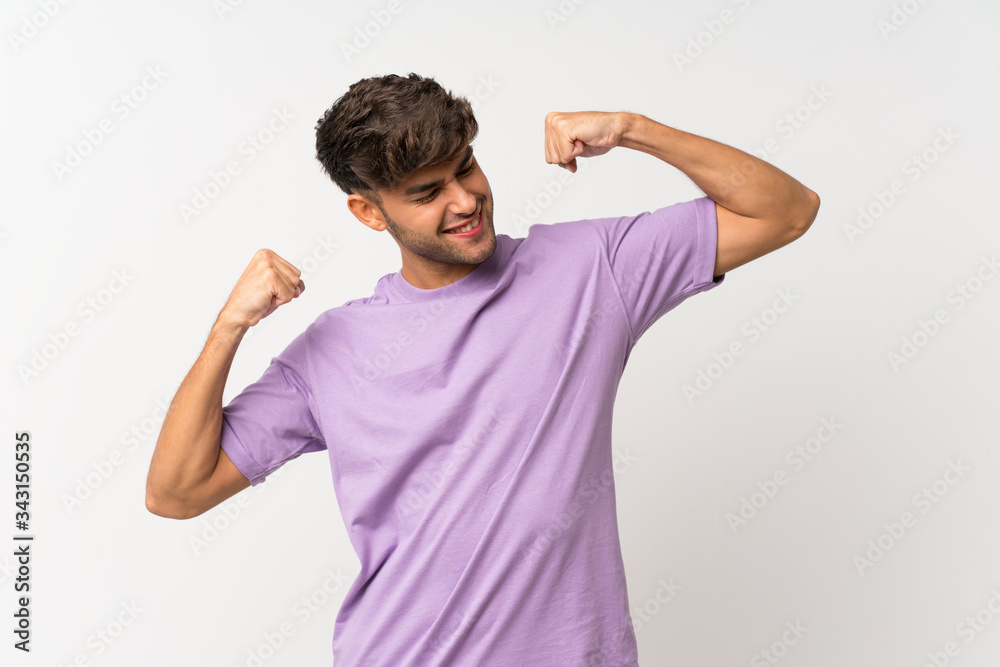 Young handsome man over isolated white background celebrating a victory Young handsome man over isolated white background celebrating a victory