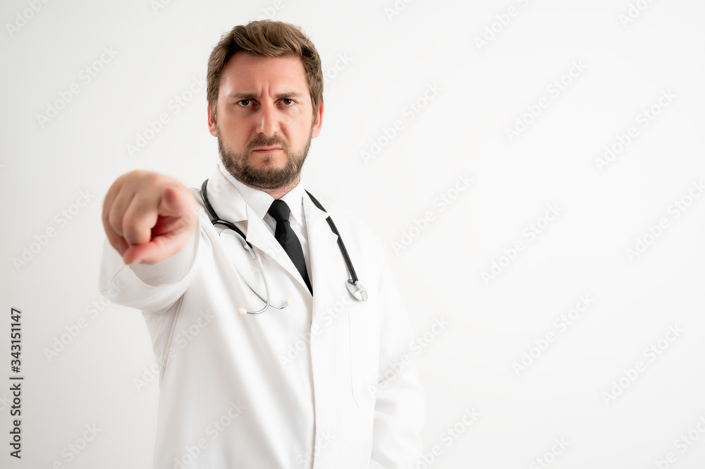 Male doctor with stethoscope in medical uniform pointing her finger