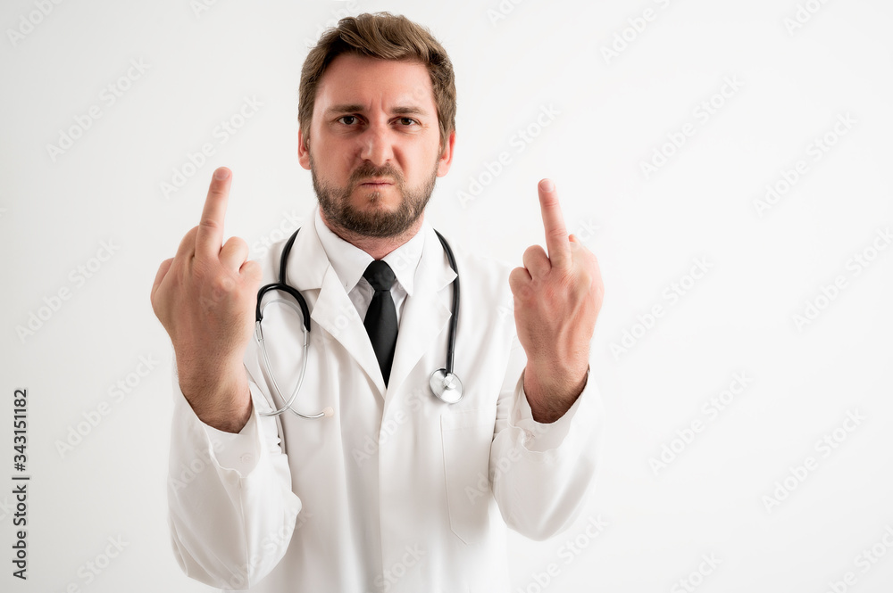 Male doctor with stethoscope in medical uniform showing double fuck you Male doctor with stethoscope in medical uniform showing double fuck you