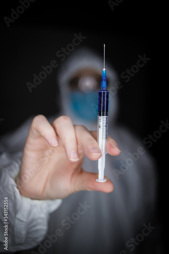 Close up portrait image of a health worker wearing protective clothing and masks working with Vaccines for dangerous viruses