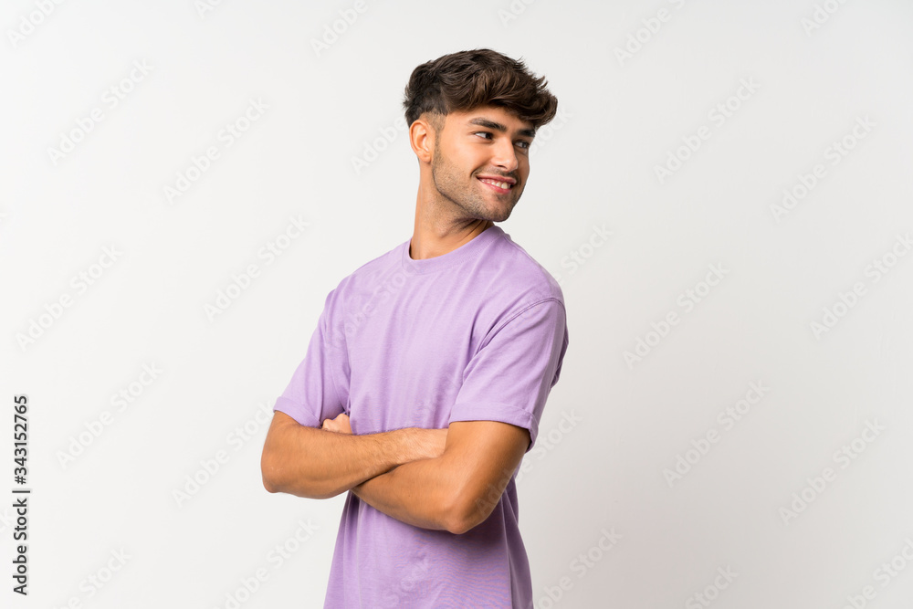Young handsome man over isolated white background with arms crossed and happy Young handsome man over isolated white background with arms crossed and happy