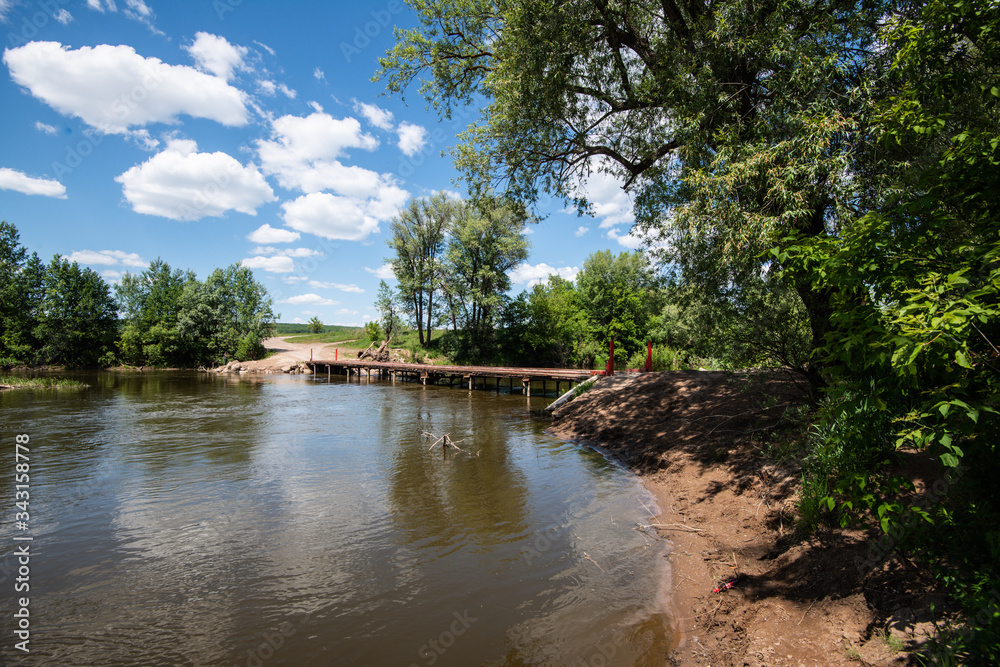 Obraz premium A small makeshift bridge over a narrow river