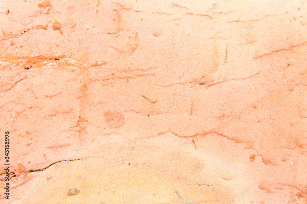 A closeup photo of a brick. Orange background. A closeup photo of a brick. Orange background.