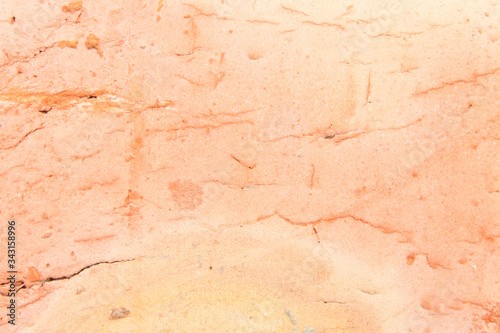 A closeup photo of a brick. Orange background.