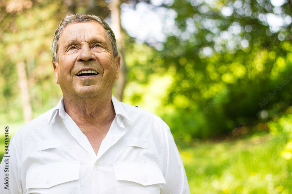 Portrait of a smiling senior man in Nature, looking at camera Portrait of a smiling senior man in Nature, looking at camera