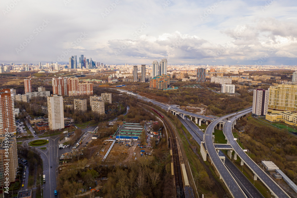 Naklejka premium panoramic view with skyscrapers and highways of a big city filmed from a drone