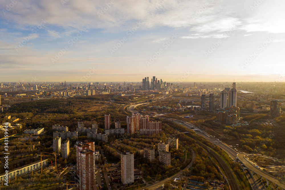 panoramic view with skyscrapers and highways of a big city filmed from a drone