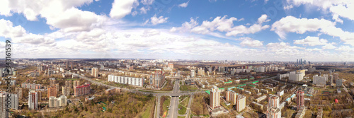 panoramic view with skyscrapers and highways of a big city filmed from a drone © константин константи