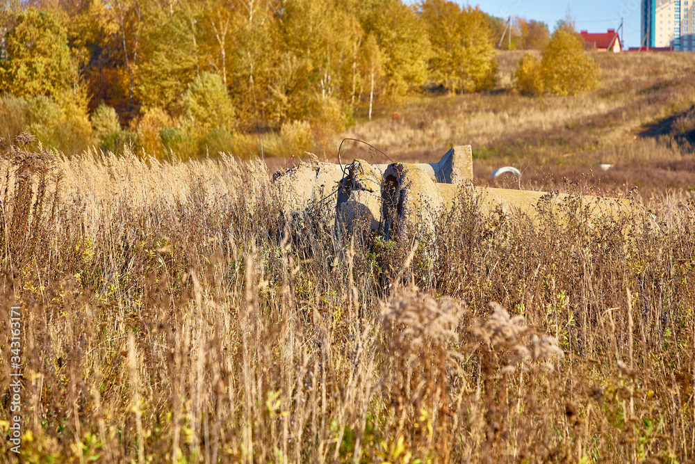 Close-up of a concrete well in the grass