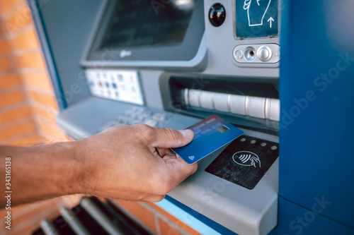 Contactless withdrawal from an ATM by credit card, finance concept