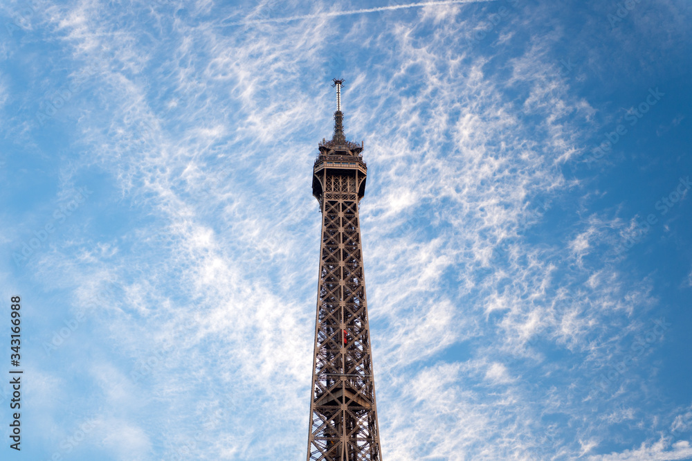 Telecommunications and broadcasting. Tower top on cloudy blue sky. TV tower outdoors. Mast or tower. Transmitting antenna. Lattice type steel tower. Metal structure and construction Telecommunications and broadcasting. Tower top on cloudy blue sky. TV tower outdoors. Mast or tower. Transmitting antenna. Lattice type steel tower. Metal structure and construction