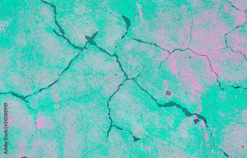 Colorful bright background. Wall with peeling plaster, tinted in pink and blue. Modern urban building concept. Bright neon backdrop. Selective focus. Copy space.