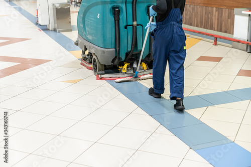 Floor care and cleaning services with washing machine in supermarket. disinfection and sanitization photo
