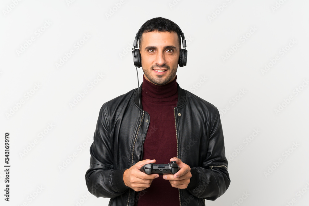 Young man over isolated white background playing at videogames Young man over isolated white background playing at videogames