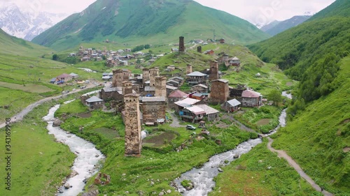 Ancient stone towers and Ushguli village at the foot of Mt. Shkhara. Picturesque and gorgeous scene. Rock tower towers and old houses in Ushguli.