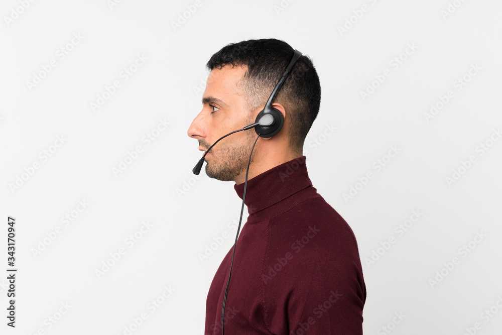 Young man over isolated white background working with headset