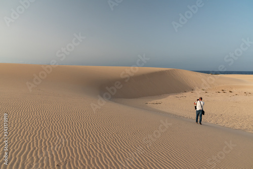 man walking on the sand dunes