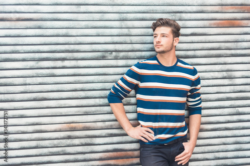 Beautiful man posing, handsome guy with colorful sweatshirt