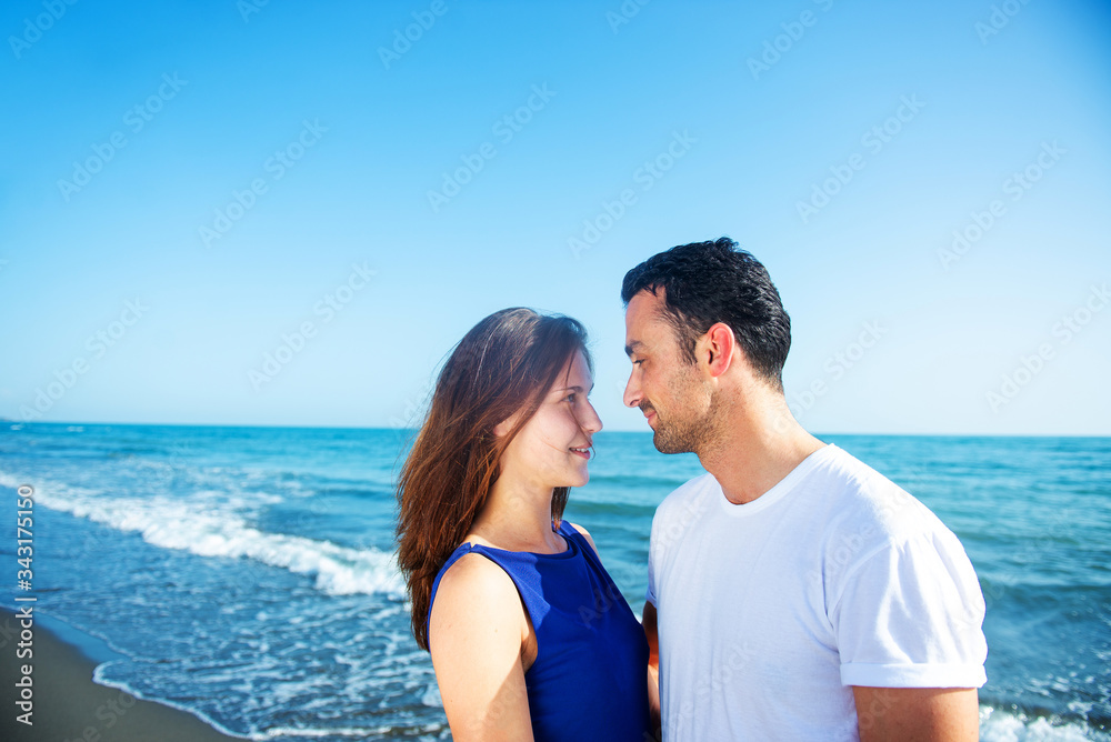 Young happy couple on seashore