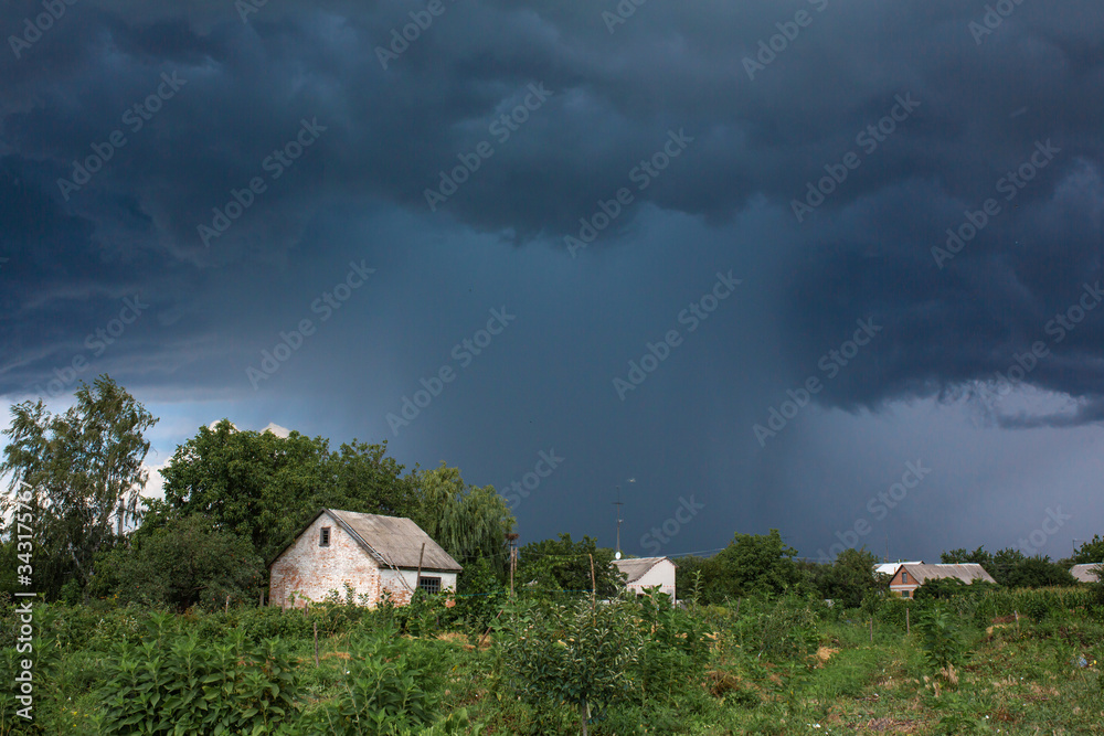 Heavy rain near an old abandoned house in a distant village. Green nature Heavy rain near an old abandoned house in a distant village. Green nature