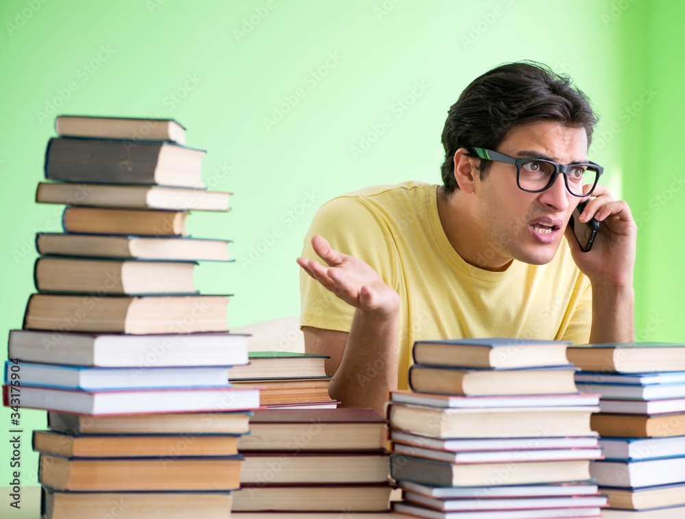 Student with too many books to read before exam Student with too many books to read before exam