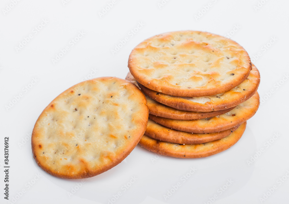 Stack of round organic crispy salty crackers on white.Top view Stack of round organic crispy salty crackers on white.Top view