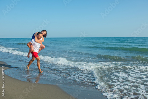 Young happy couple on seashore 