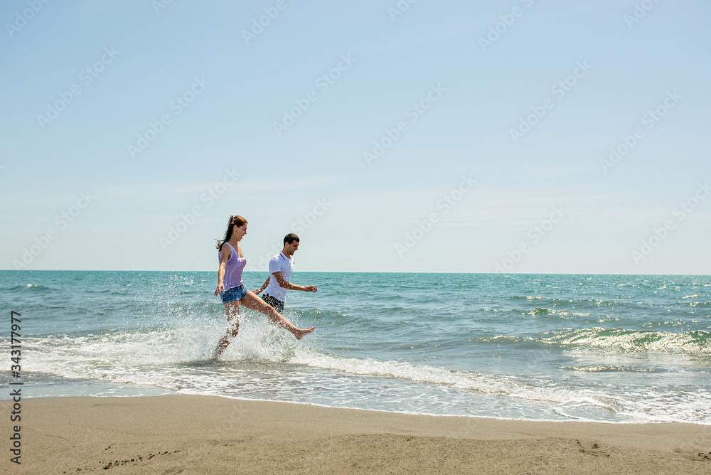Young happy couple on seashore Young happy couple on seashore