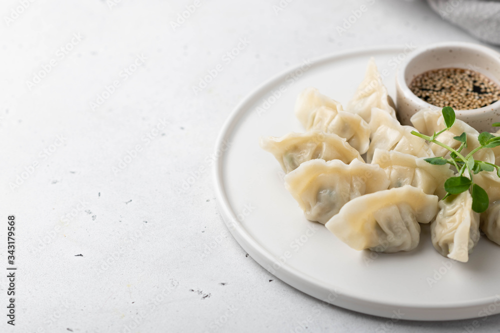 Korean dumplings with soy sauce on a white background , asian food.