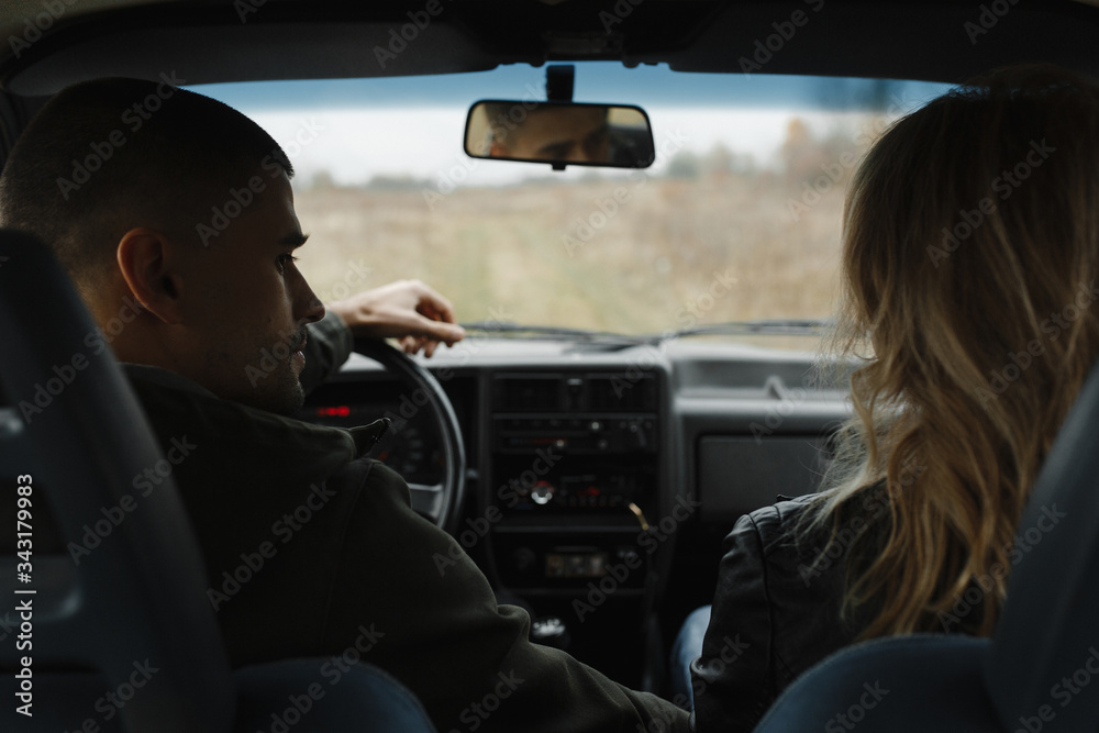 Man looking at his woman while sitting in the car Man looking at his woman while sitting in the car
