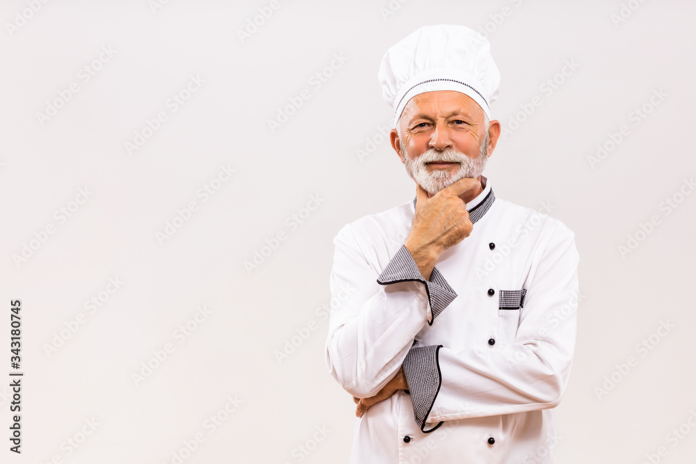 Portrait of senior chef thinking on gray background. Portrait of senior chef thinking on gray background.
