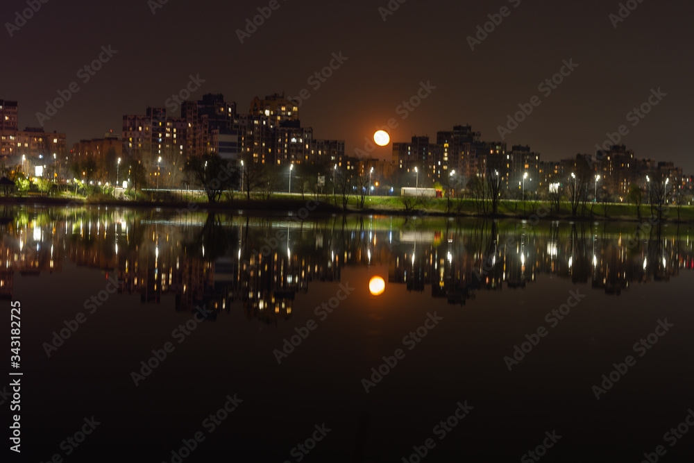 Night city Kiev is reflected in the water.